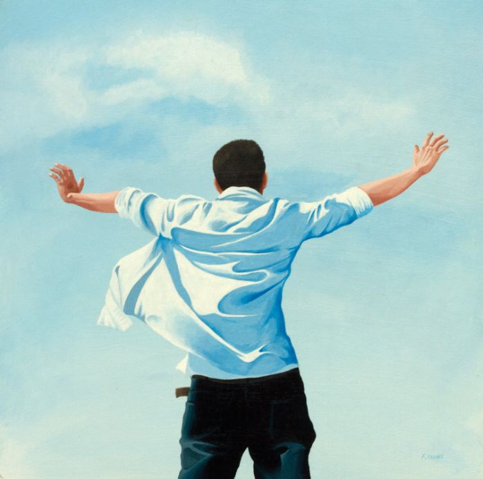Man from behind, arms outstretched against a blue sky