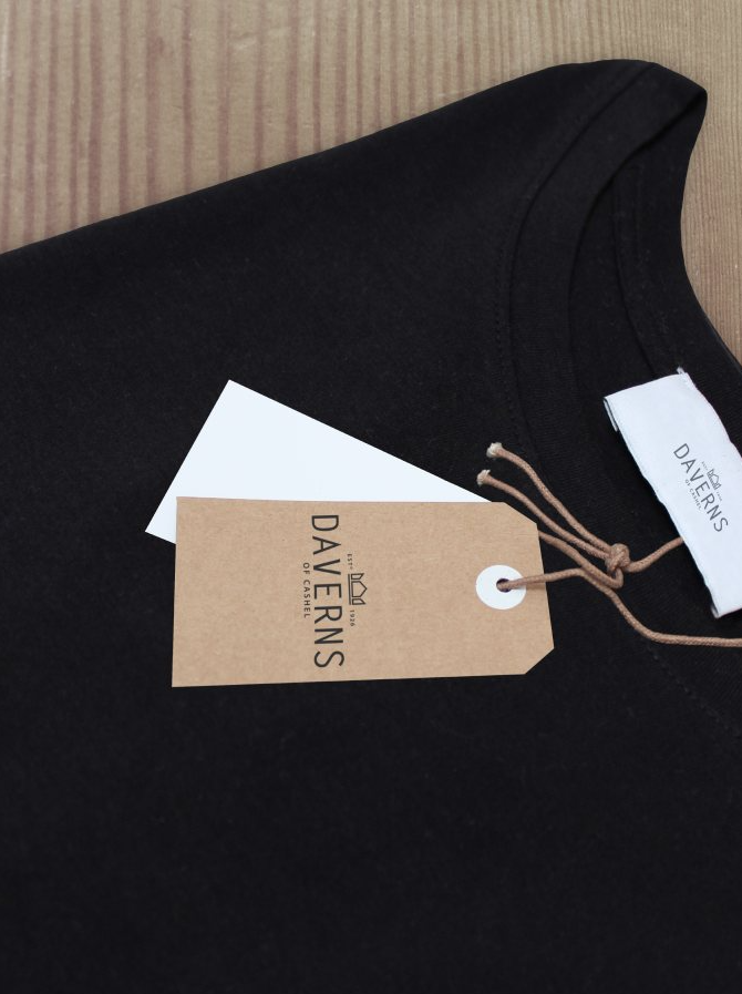 Kraft swing tag and woven label on a black garment